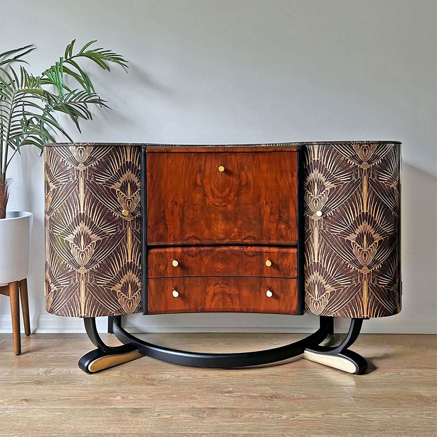 1920s Art Deco Beautility walnut cocktail cabinet with black and gold details, featuring Divine Savages feathery print and solid brass handles