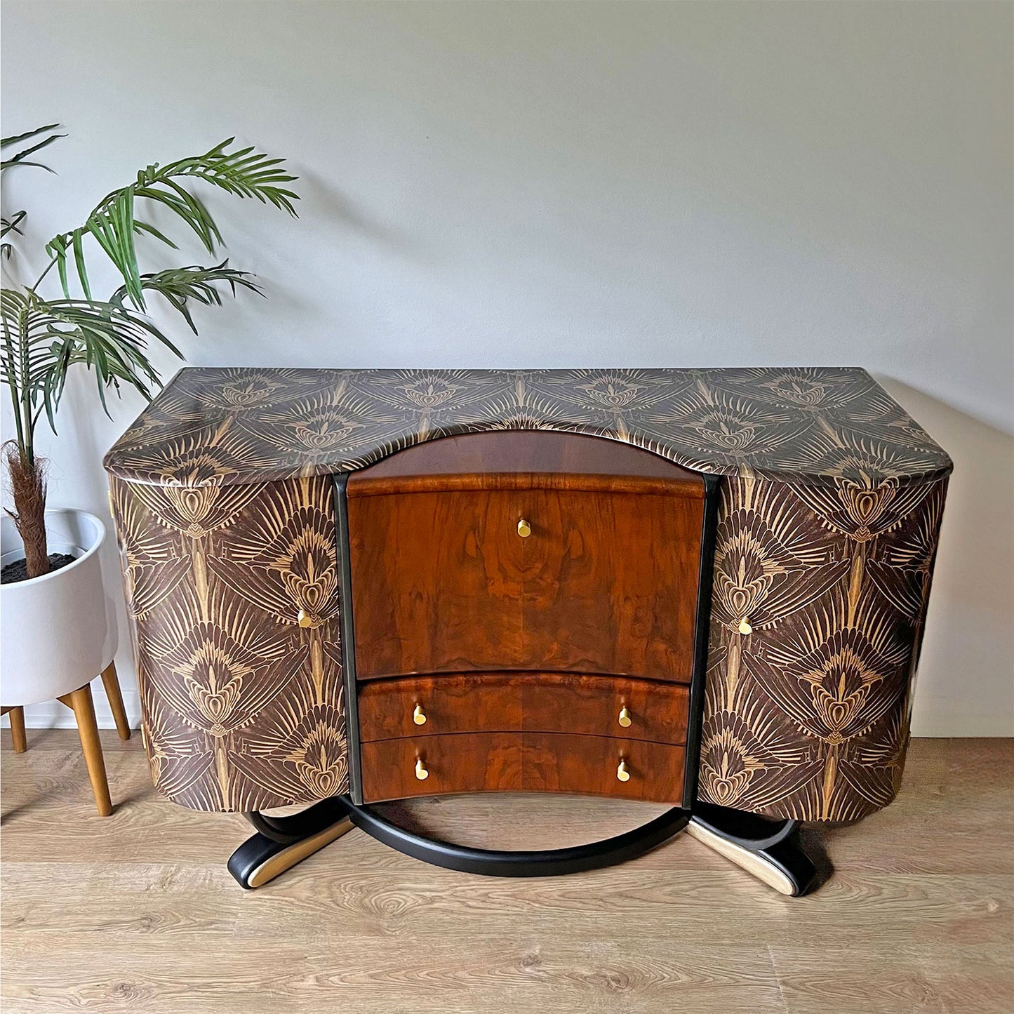 Close-up of Beautility cocktail cabinet’s top, encased in Divine Savages feathery Art Deco Gershwing print with rich walnut woodgrain.