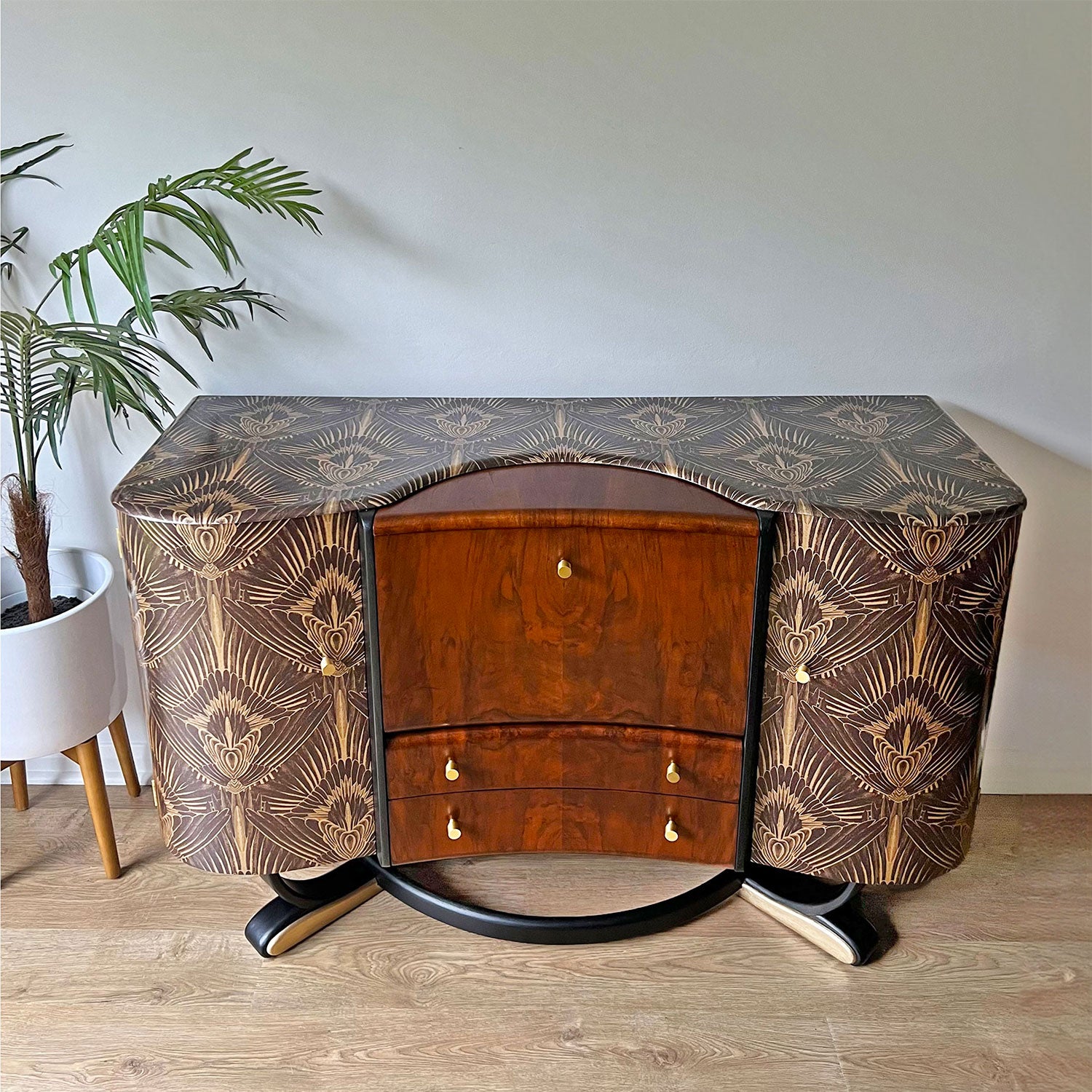 Close-up of Beautility cocktail cabinet’s top, encased in Divine Savages feathery Art Deco Gershwing print with rich walnut woodgrain.