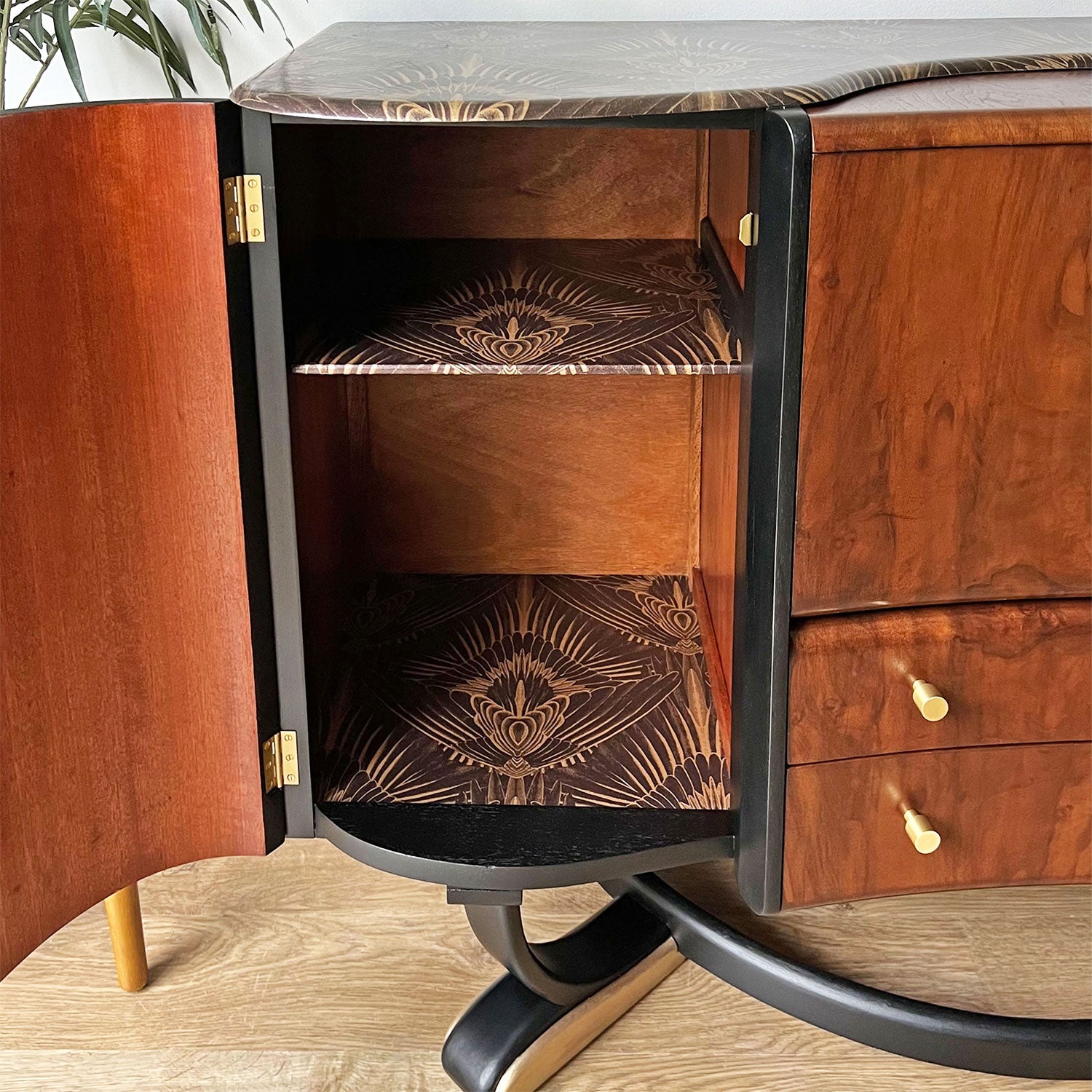 Spacious side cabinet inside Beautility cocktail cabinet, featuring Gershwing decoupage and ample storage for wine and spirits.