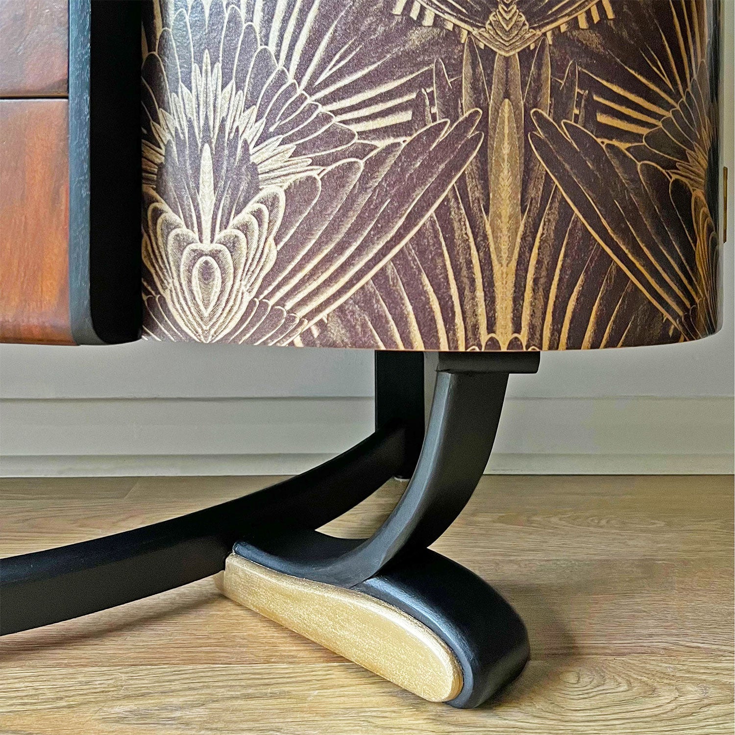 Elegant curved legs of Art Deco cocktail cabinet, refinished in specialist black and gold paint with felt sliders for floor protection.