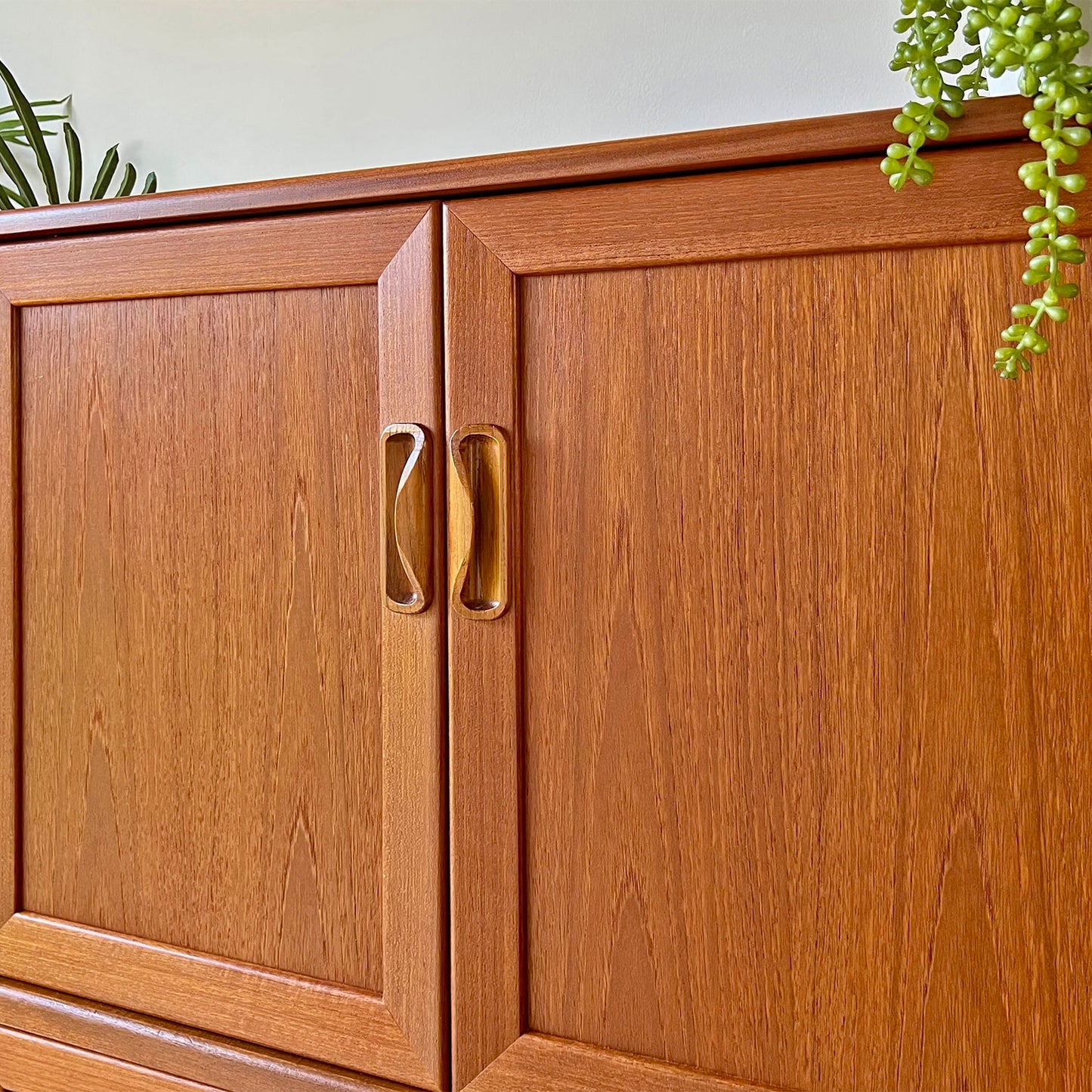 Close-up of the original G Plan cabinet handles, featuring a hand-restored teak finish and Mid-Century Modern craftsmanship.