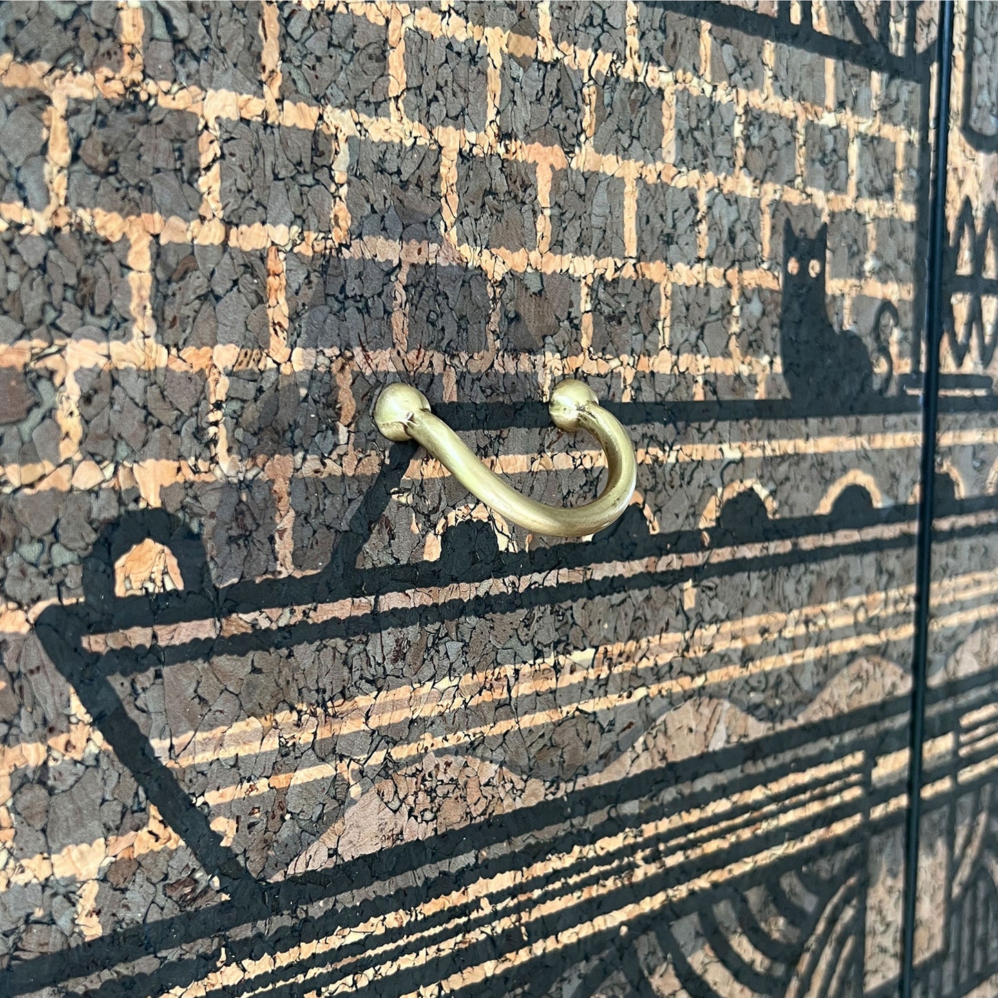 Detailed view of the Portuguese cork print designed by Drew Millward, featuring skull, lightbulb, and rose motifs on a G Plan Librenza drinks cabinet.