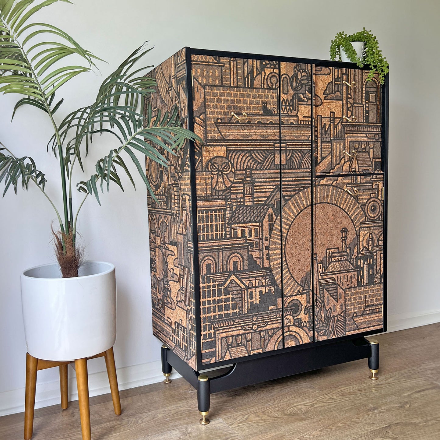 Side profile of the bespoke G Plan Librenza drinks cabinet, showcasing its mid-century form and artistic cork print exterior.
