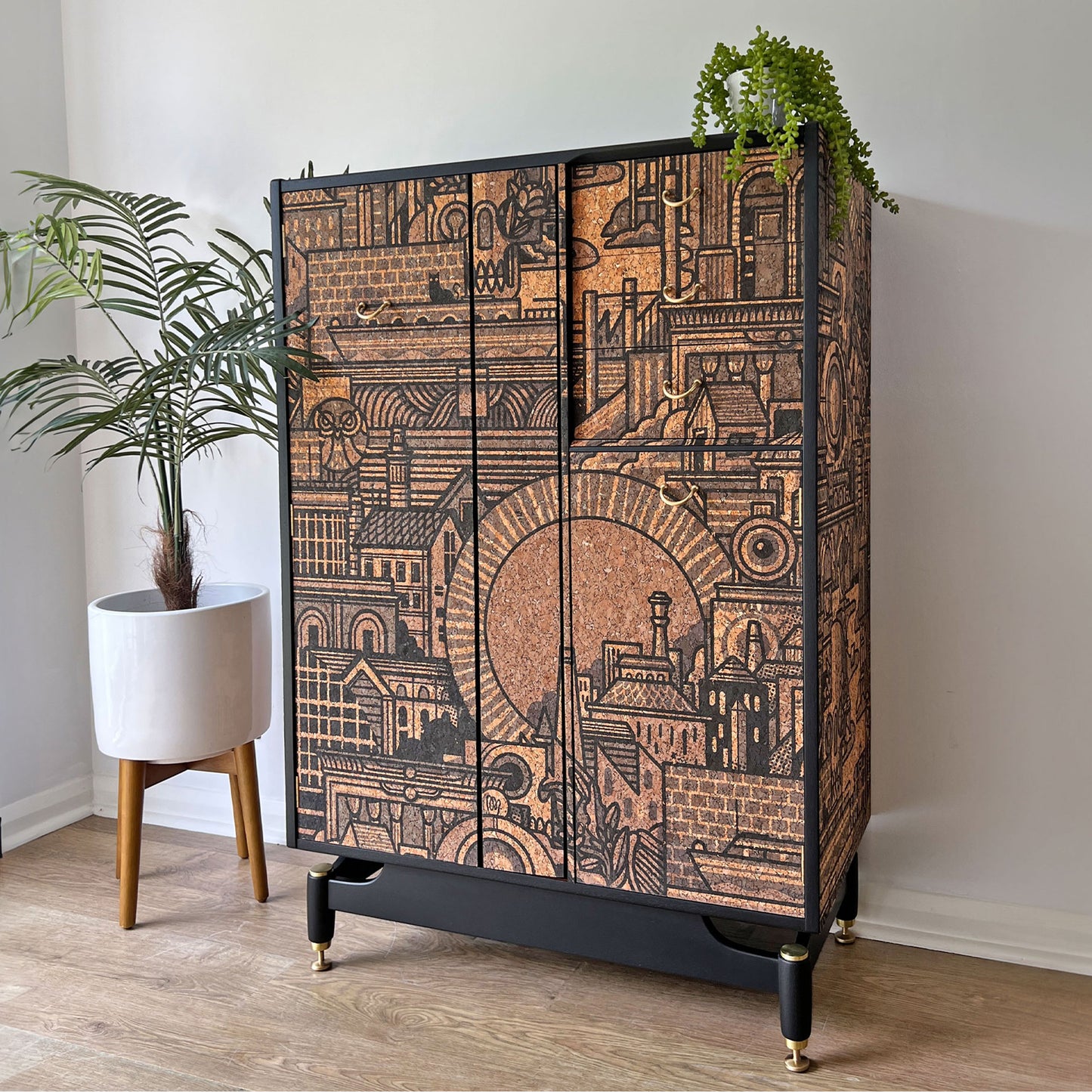 Side profile of the bespoke G Plan Librenza drinks cabinet, showcasing its mid-century form and full wrap of artistic cork print exterior.