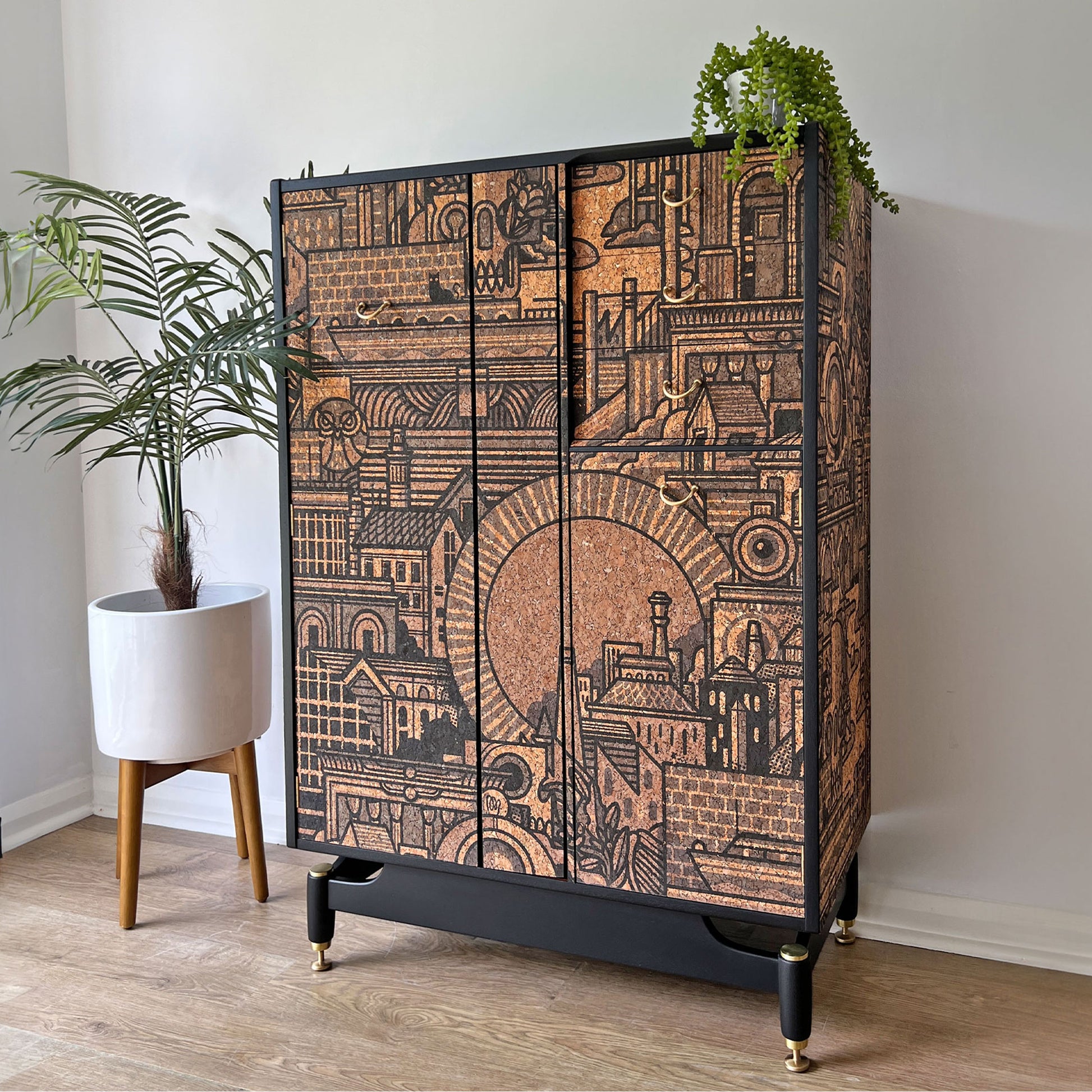 Side profile of the bespoke G Plan Librenza drinks cabinet, showcasing its mid-century form and full wrap of artistic cork print exterior.