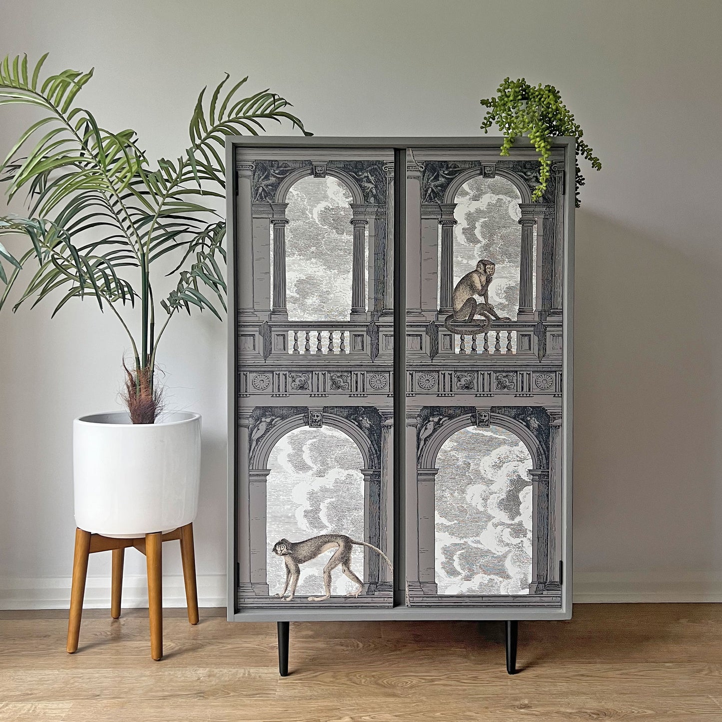 Luxury drinks cabinet with sleek matte black tapered legs, blending mid-century modern craftsmanship with contemporary design.