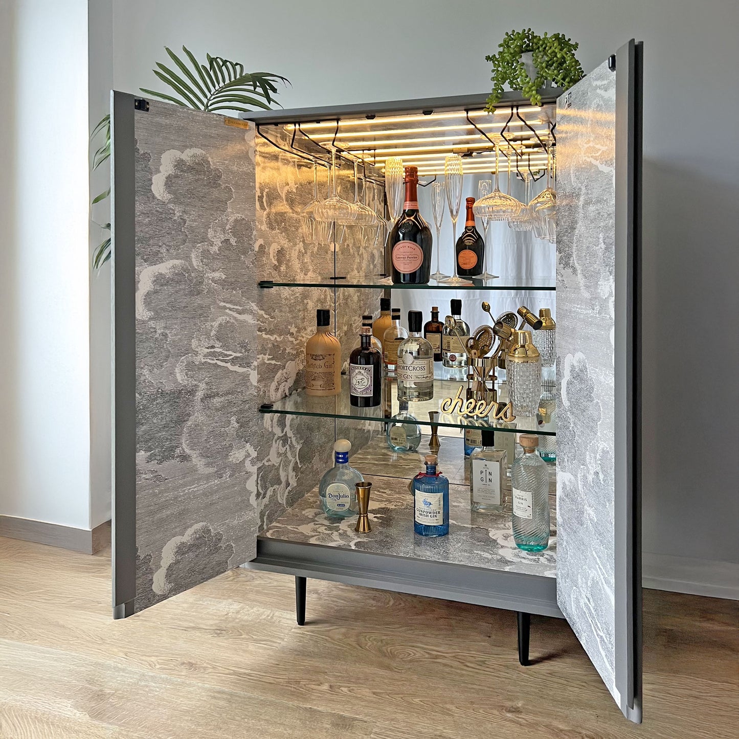 Bespoke John & Sylvia Reid Stag C Range drinks cabinet styled in a high-end interior, showcasing Fornasetti design and luxury craftsmanship.