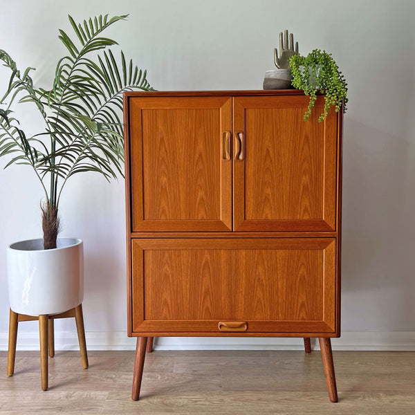 Bespoke G Plan drinks cabinet, a restored Mid-Century Modern teak cocktail bar with brass accents and a sleek, minimalist design.