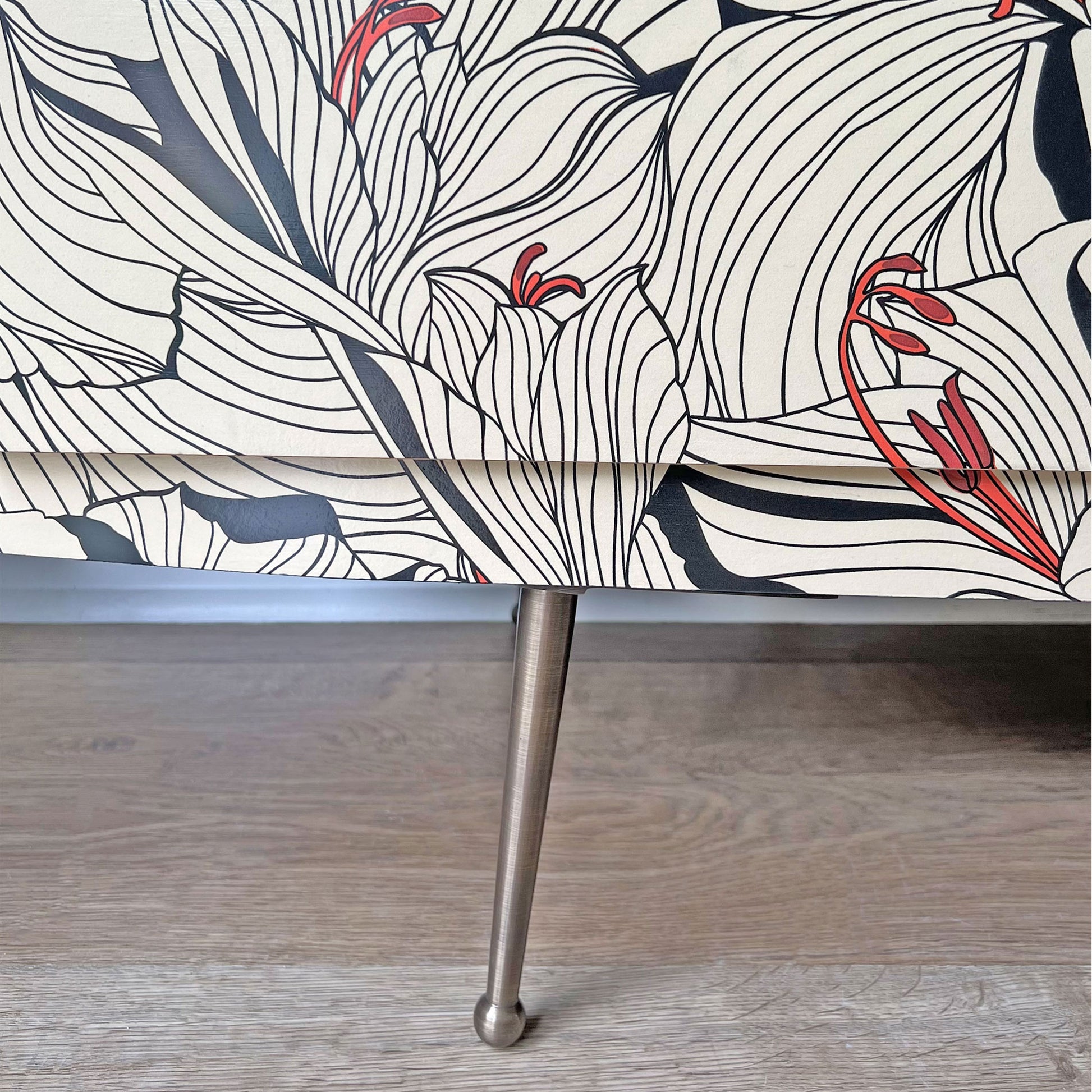 Close-up of Gucci 'Lilies' decoupage design in cream and black on Beautility sideboard, adding a luxurious and artistic touch.