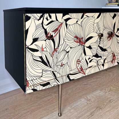 Side profile of Beautility sideboard, showcasing black painted sides, Gucci 'Lilies' decoupage, and antiqued brass accents.