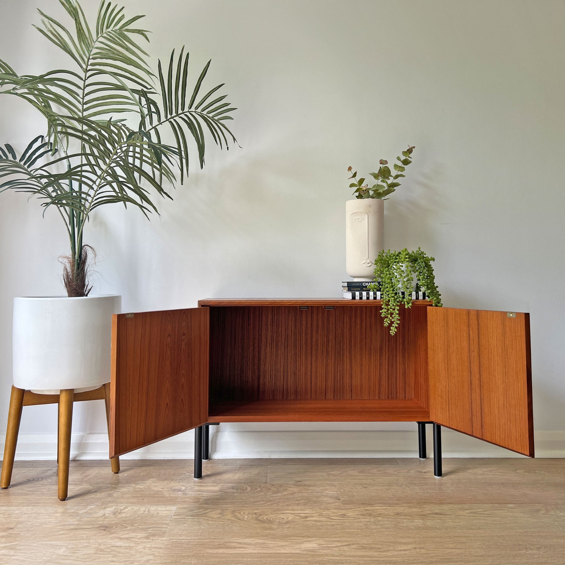 Open G Plan cabinet featuring a spacious interior, complemented by the Fornasetti 'Nottambule' owl print exterior and sleek matte black legs.