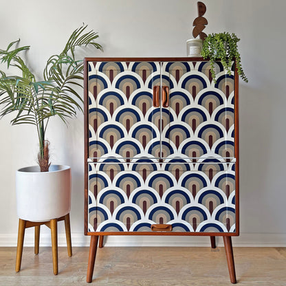 Mid-Century G Plan drinks cabinet with JUPITER 10 ‘Prague’ decoupage, featuring a mesmerising scalloped arch design in navy, taupe, and chocolate tones.