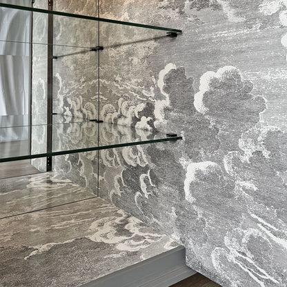 Atmospheric Fornasetti 'Nuvolette' cloudscape design inside drinks cabinet, creating an illusion of an endless sky.
