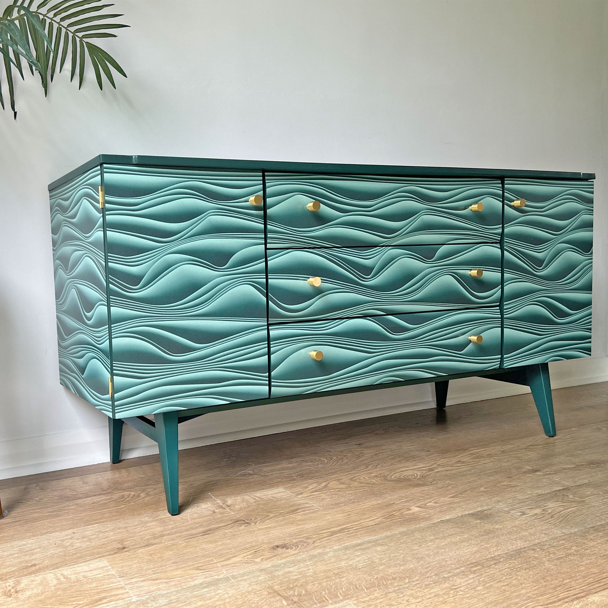 Close-up of Marianas decoupage on Meredew sideboard, featuring a dynamic 3D paper fold design by Carmine Lake for a bold, fluid effect.