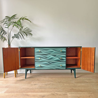 Refinished Meredew sideboard with revitalised wood interior, showcasing spacious storage with three drawers and a cupboard with fixed shelves.