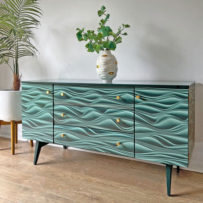 Side profile of Meredew sideboard, showcasing the bold Carmine Lake Marianas decoupage and sleek brass hardware.