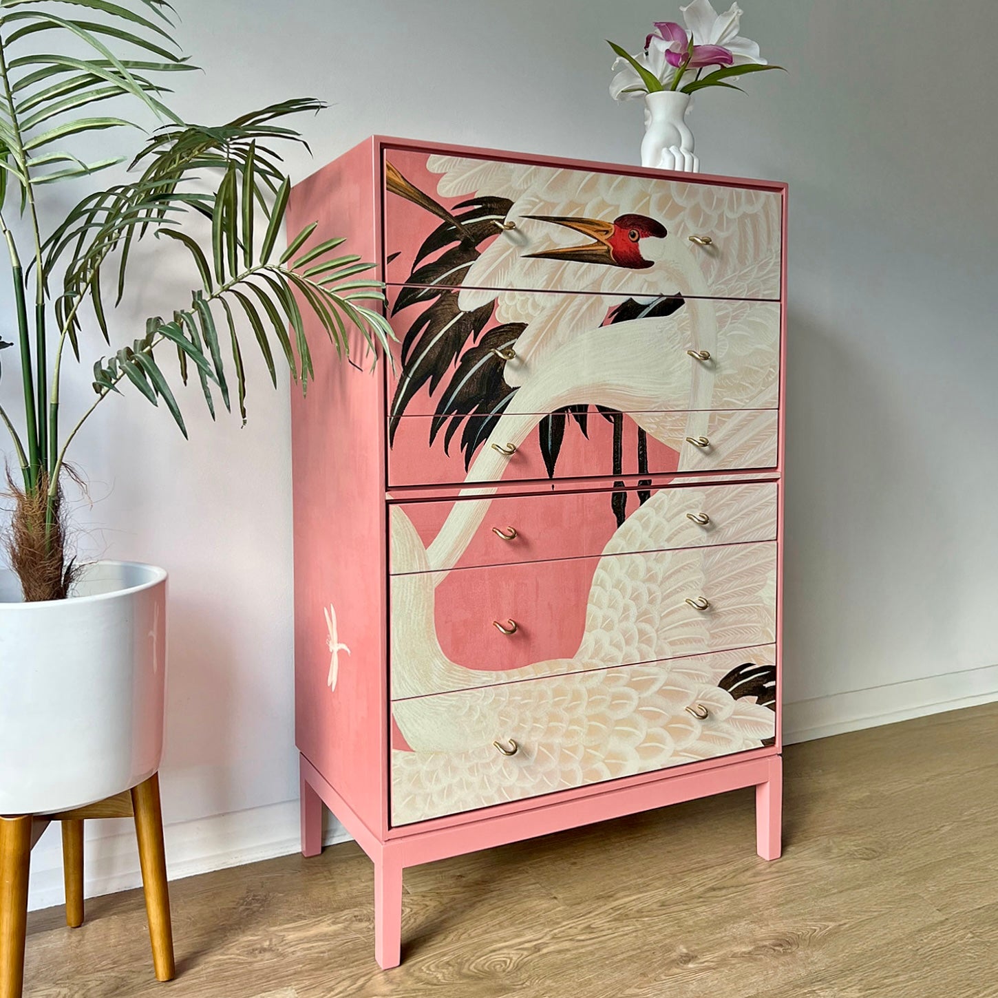 Side profile of Stag C Range tallboy, featuring bold pink Gucci Heron decoupage and sleek Mid-Century Modern construction.